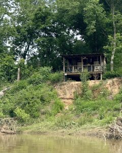 A small, quiet cabin on the banks of a river